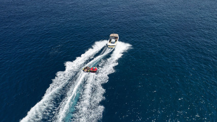 Aerial photo of extreme powerboat donut watersports crusing in high speed in tropical turquoise bay