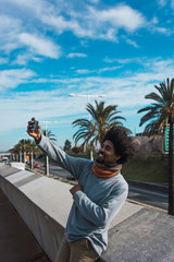 Fototapeta na wymiar Portrait of black man with afro hair while looking at his smartphone