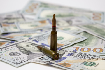 bullets on american dollars background Ammunition from the gun on money bills
