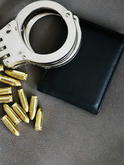 Handcuffs, pistol bullets and wallet