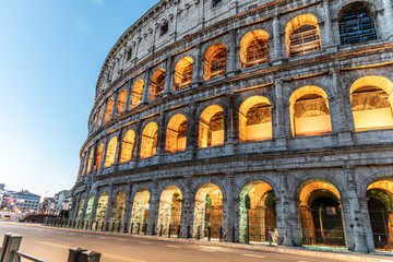 Fototapeta premium Colosseum, or Coliseum. Illuminated huge Roman amphitheatre early in the morning, Rome, Italy
