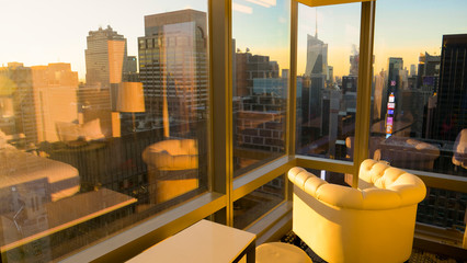 CLOSE UP: Morning sunshine illuminates the hotel room with a view of the city