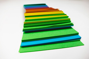 A stack of multicolored note papers on an isolated white background. isolates