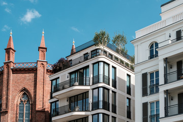 modern apartment buildings and old church facade -  real estate Berlin, Mitte