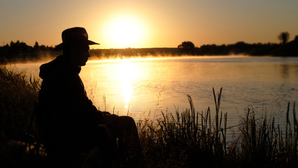 Sunrise on the lake.fisherman on a lake.