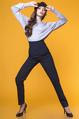 Fototapeta na wymiar teen girl posing in studio on yellow background