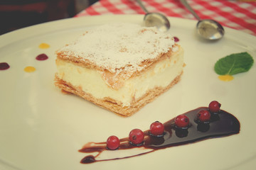 sweet caloric papal fondant served with on white plate with fruit with a silver steel spoon