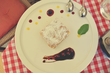 sweet caloric papal fondant served with on white plate with fruit with a silver steel spoon