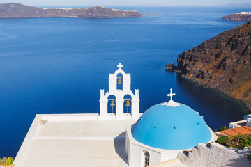 Fototapeta na wymiar Famous beautiful church with blue dome in Firostefani on Santorini island, Greece.
