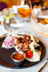 Barbecue with onions in pita bread and sauce