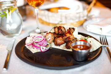 Barbecue with onions in pita bread and sauce