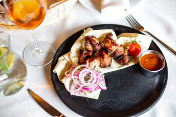 Barbecue with onions in pita bread and sauce