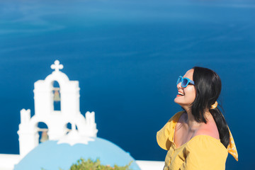 Fototapeta na wymiar Woman Standing By Church Against Sky, Thira, Santorini, Greece