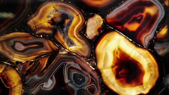 Natural gemstone agate with red and gold shades, close-up
