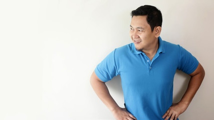 Fototapeta premium Young Asian Man Smiling Happily Looking to The Side