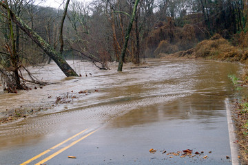 Road Swamped By Flooding River