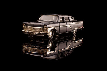 Luxury black USSR car die-cast model on the black reflective background