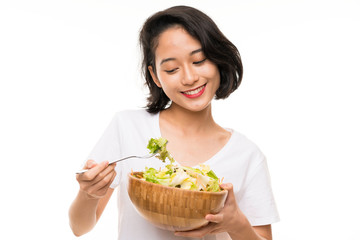 Asian young woman over isolated background with salad