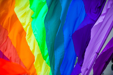 Rainbow flag parachute fabric fills the frame for a colorful background of gay pride,...