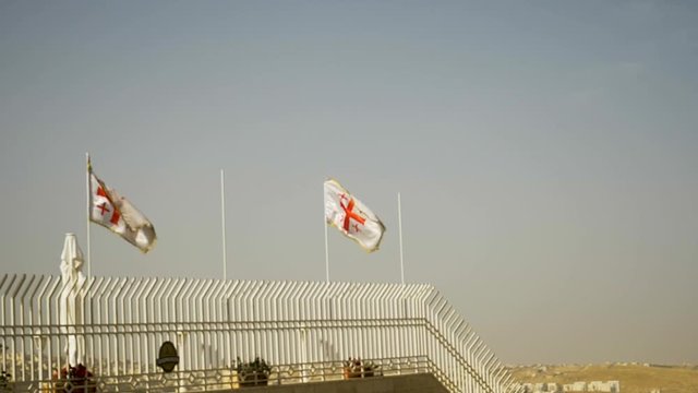 The Jerusalem cross flags or five-fold cross flags waving in the wind - slow motion