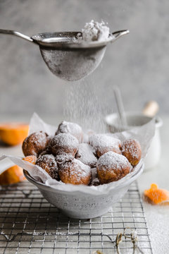 Powdered sugar dusting over cara cara fritters