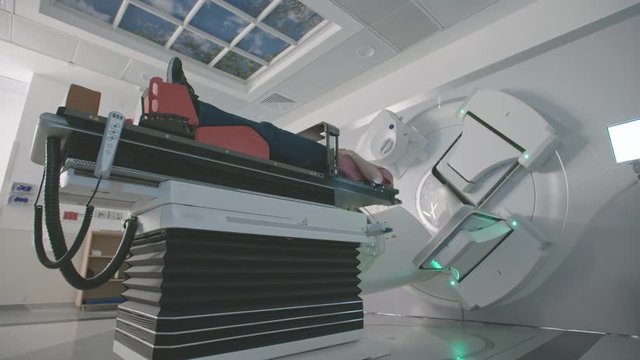 Patient Getting Radiation Therapy Treatment Inside A Modern Radiotherapy Room