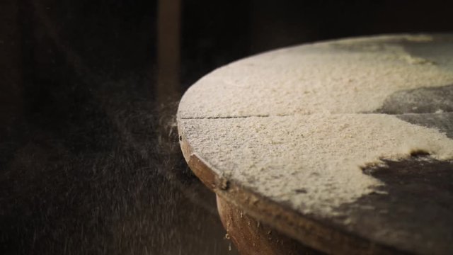 Slow motion. Wood sawdust on the wooden table