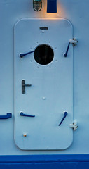 Waterproof door with lamp on a ship. Emergency door.