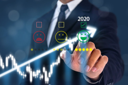 2020 man point hand to the  happy face satisfication with bussiness experiance with graph growth in 2020