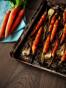 Roasted carrots and shallots on a tray