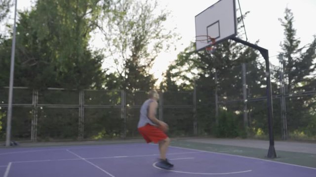young guys are training to play on the playground in basketball score goals throw the ball