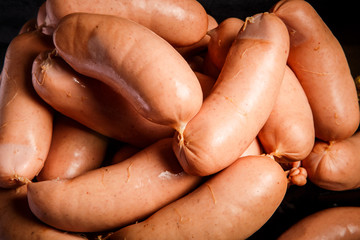 macro view pile of short thick wieners rolled in spiral on scales