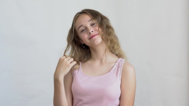 close-up of a teenager girl model with long hair posing on a white background