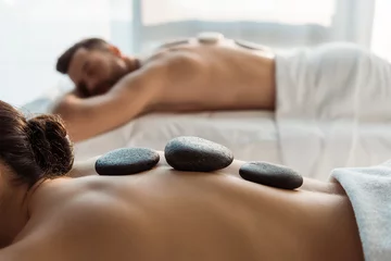  selective focus of woman having stone massage near man in spa center © LIGHTFIELD STUDIOS