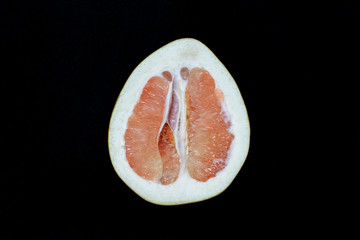 fruit Pamela one half on a black background