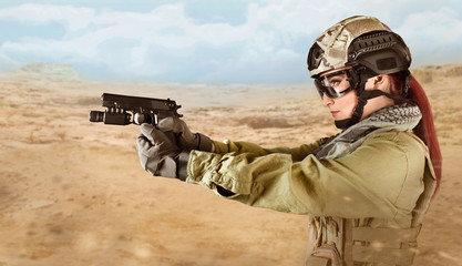 Young soldier woman aiming at the enemy with pistol