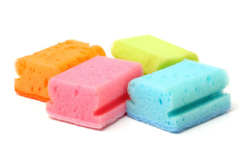 Brightly colored sponges on white background with copy space