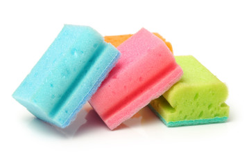 Brightly colored sponges on white background with copy space