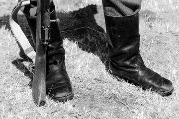 Soldier in boots with gun.