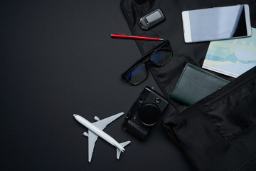 Outfit ,accessories and equipment of traveler on black background with copy space .travel concept .