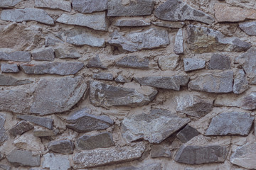 wild decorate stone wall texture. natural facade home dry background. old grunge rocks retro vintage wallpaper