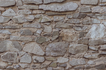 wild decorate stone wall texture. natural facade home dry background. old grunge rocks retro vintage wallpaper