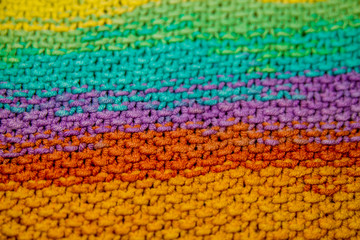 multicolor yellow, green, orange and purple horizontal knitted pattern background