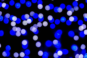 Closeup blue abstract blurred and bokeh of LED party light bubs reflection lighting at night time.