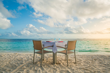 Table outdoor next to sea scenic prepare for special romantic dinner time with sunlight shading