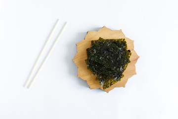 Crispy Nori Seaweed with sea salt on white background. Asian cuisine.Food background with copy space. 