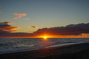 Fototapeta na wymiar Dramatic fiery sunset over the sea landscape.