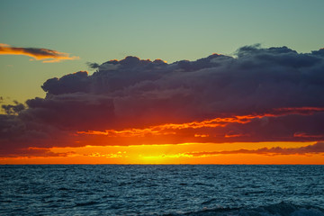 Dramatic fiery sunset over the sea landscape.