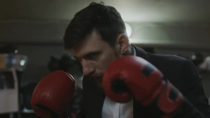 Elegand man boxing in red gloves - Powered by Adobe