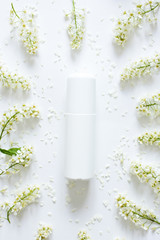 Soothing cream. Face cream with flowers extract. Closeup. White cosmetics concept on  white background with  flowers.Cosmetic and skin care concept. Copy space for your design. Beauty blog layout. 